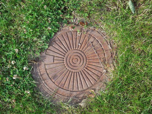 How to Hide Sewer Cover in Yard