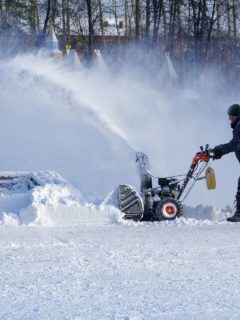 Man blowing snow with a snow blower—how to drain gas from Ariens snow blower?