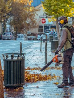 A man holding a leaf blower—electric leaf blower and gas leaf blower.