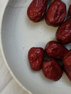 dried red berries on a white plate—how to grow jujube from seed?