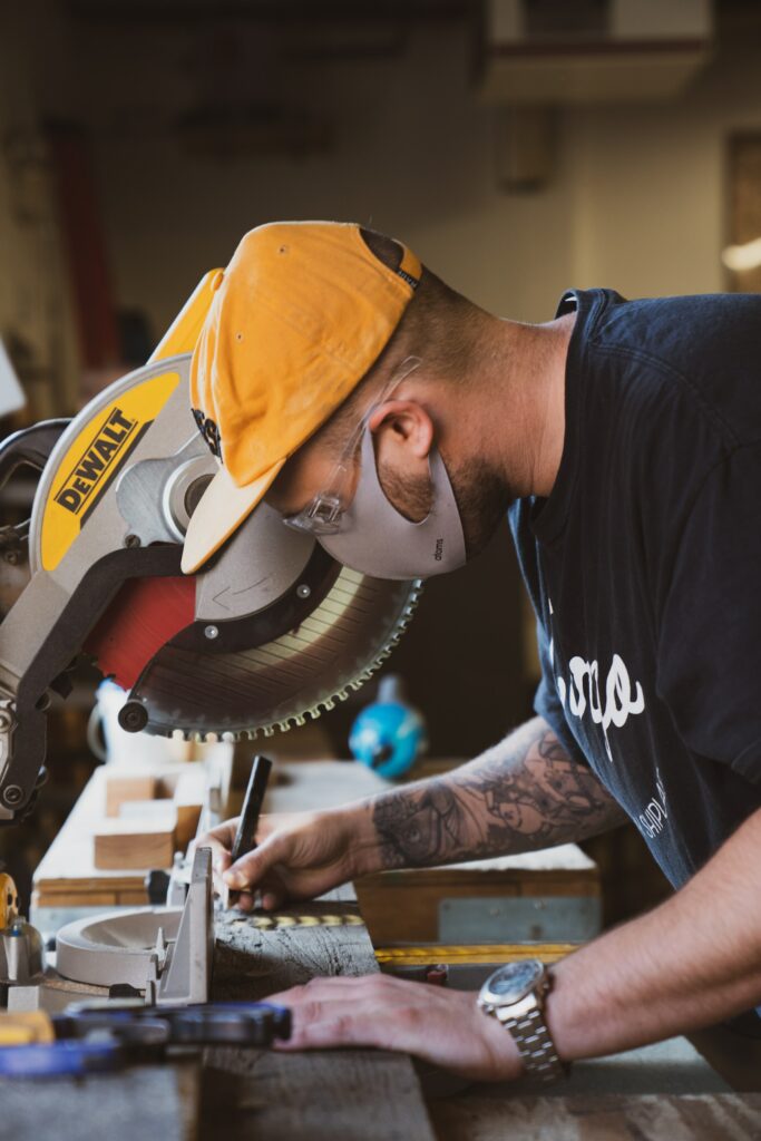 A man working with a miter saw—how to unlock a craftsman miter saw?