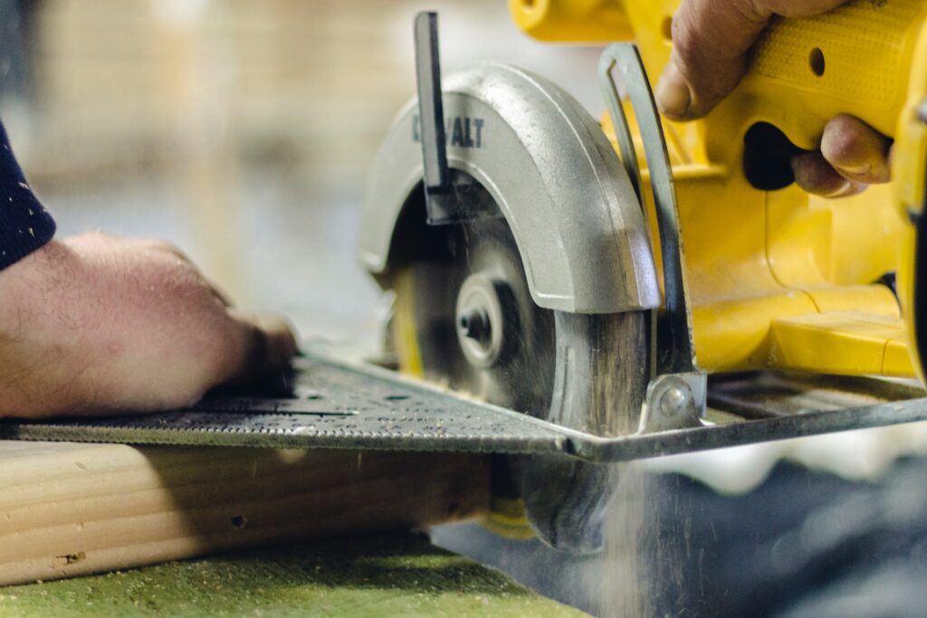 A man using a circular saw—corded vs. cordless circular saw.